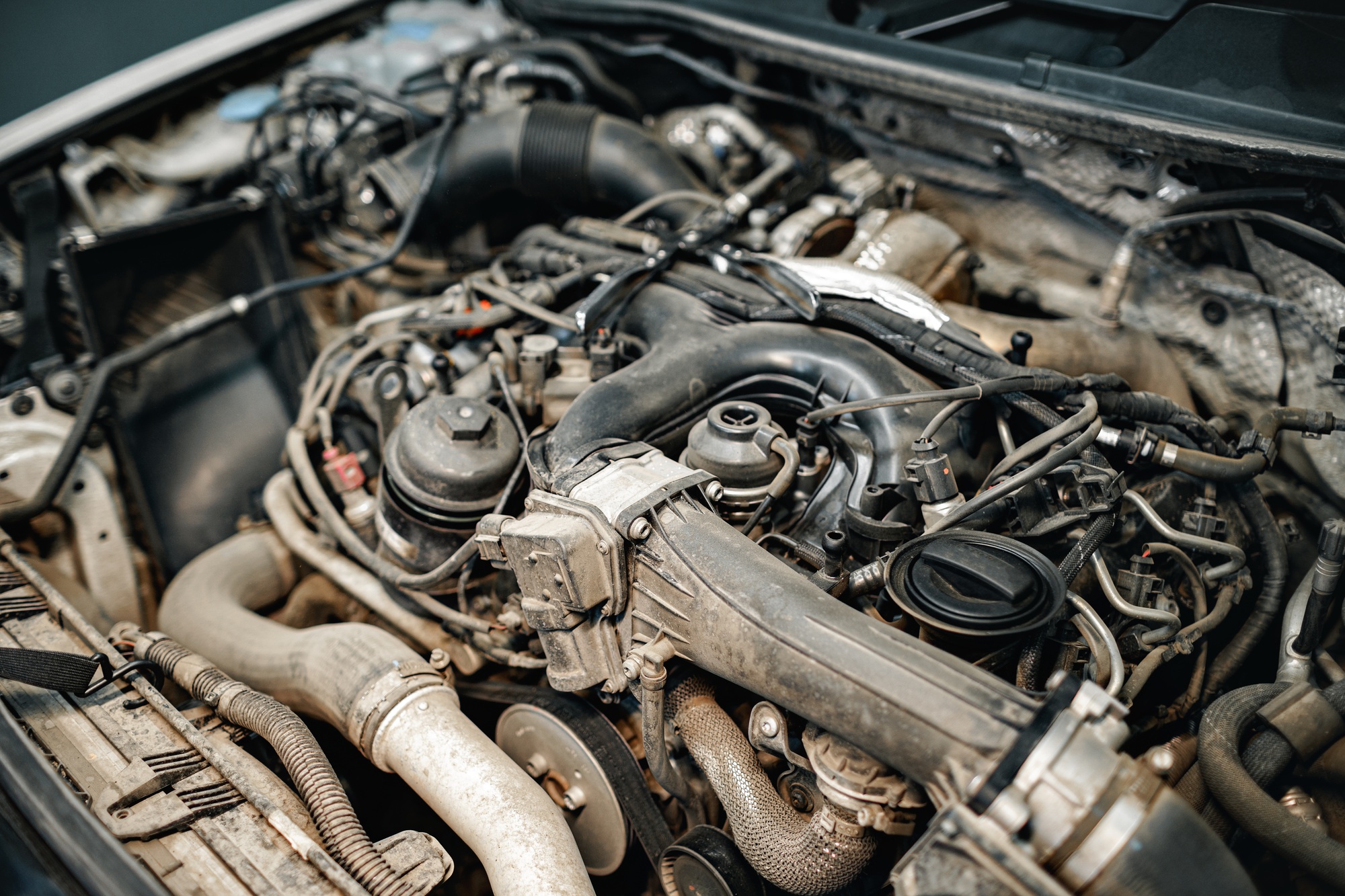 Dirty engine under the hood of a car